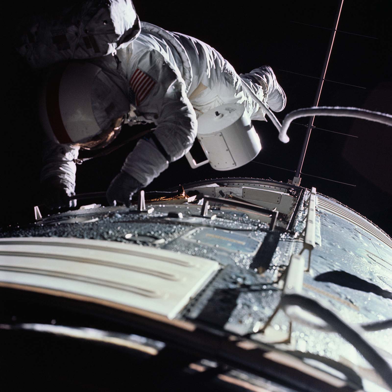 FIGURE 10. - Astronaut Ron Evans retrieving film from the SIM bay cameras while the Apollo 17 spacecraft was returning to Earth.