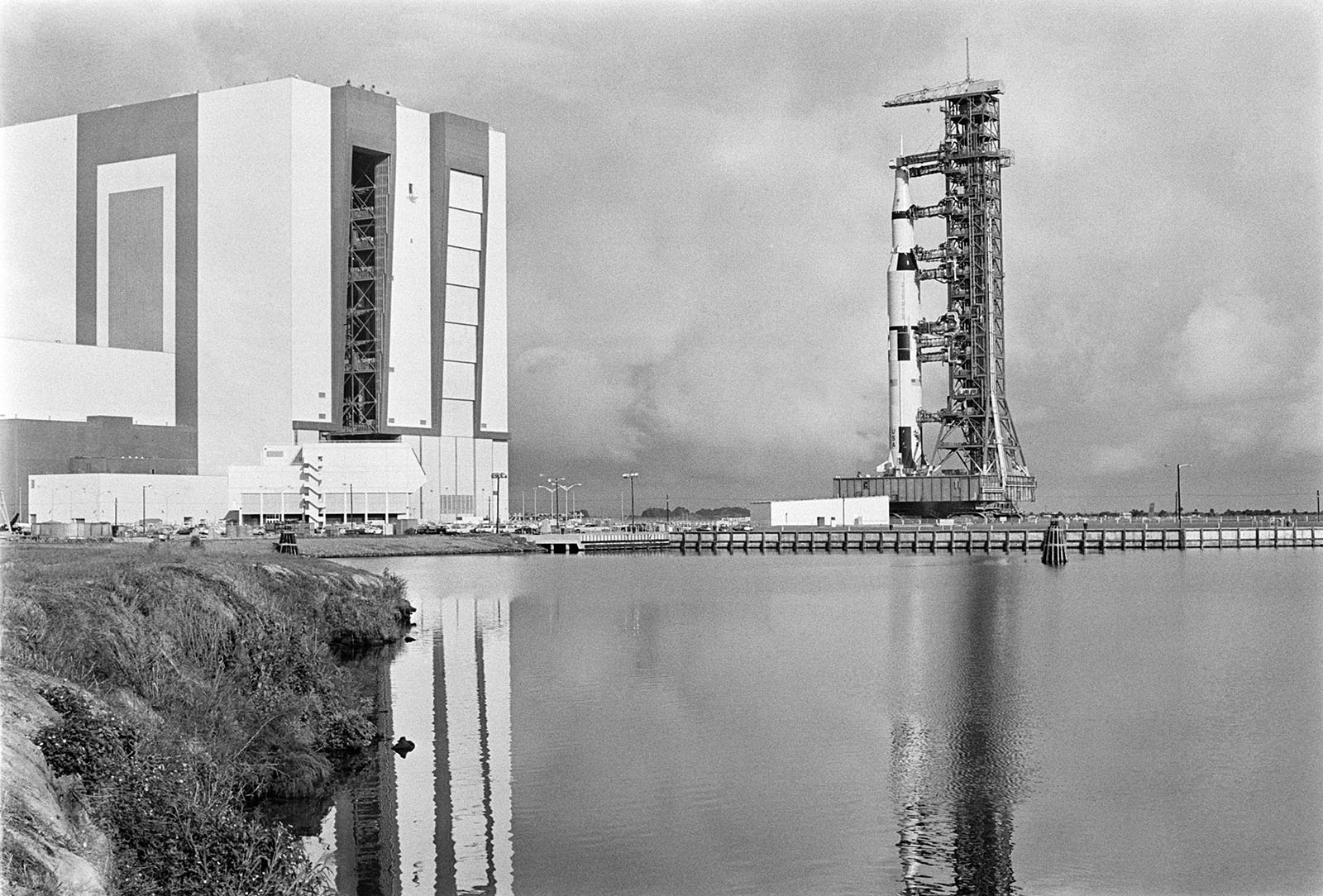 view of the rocket assembly building and a massive Saturn rocket on transport